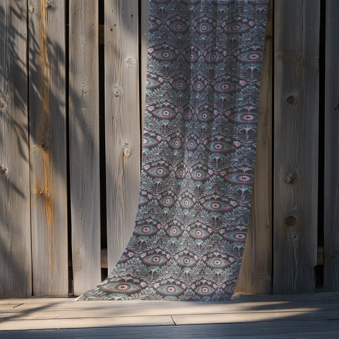 Sheer curtain panel featuring repeating sage green and blush pink evil eye motif surrounded by botanical elements on dark gray background. Linen-textured polyester fabric allows filtered light while providing elegant window covering with protective symbolism for Victorian or gothic interiors.